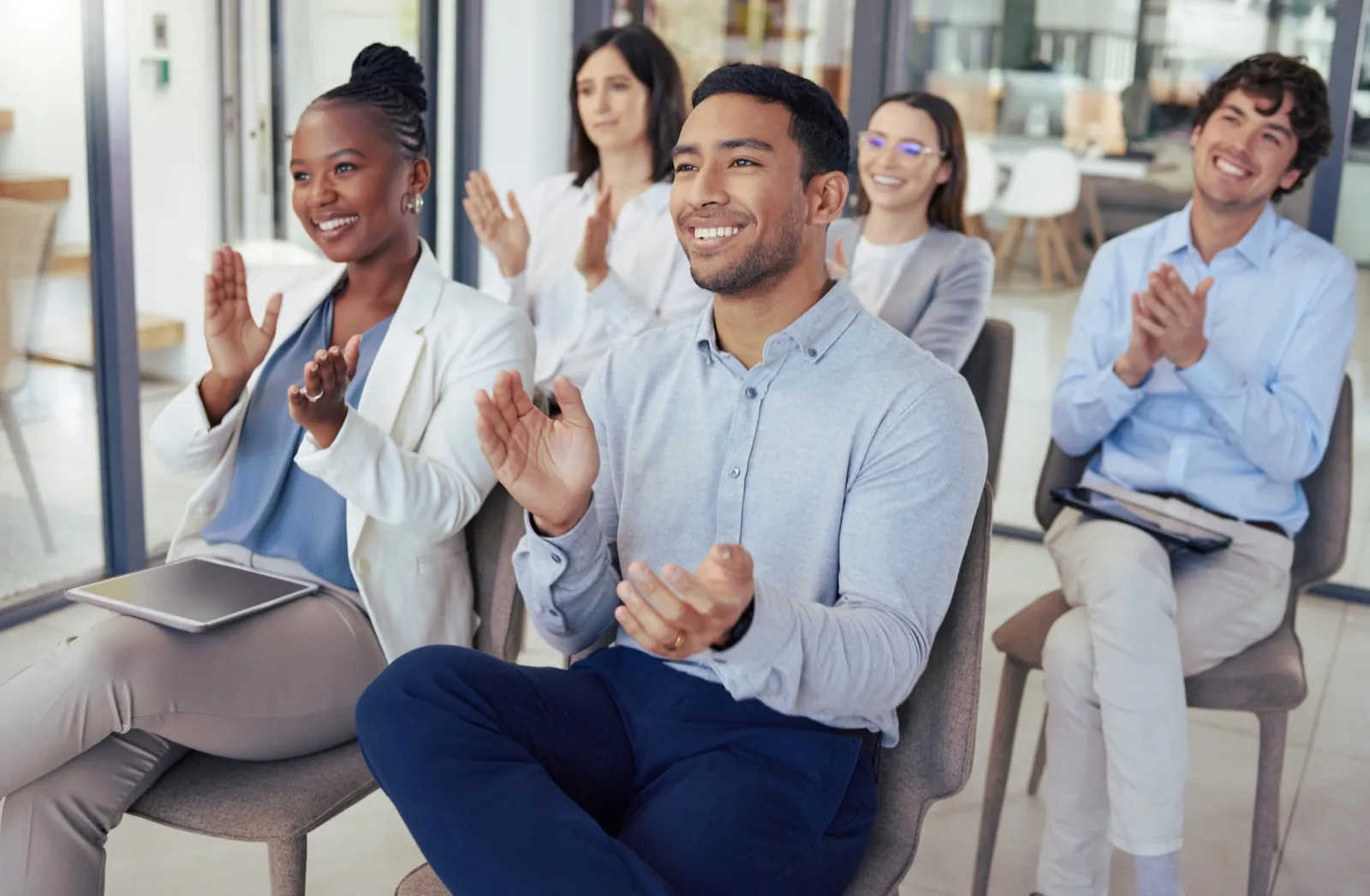 Diverse corporate team applauding at leadership workshop