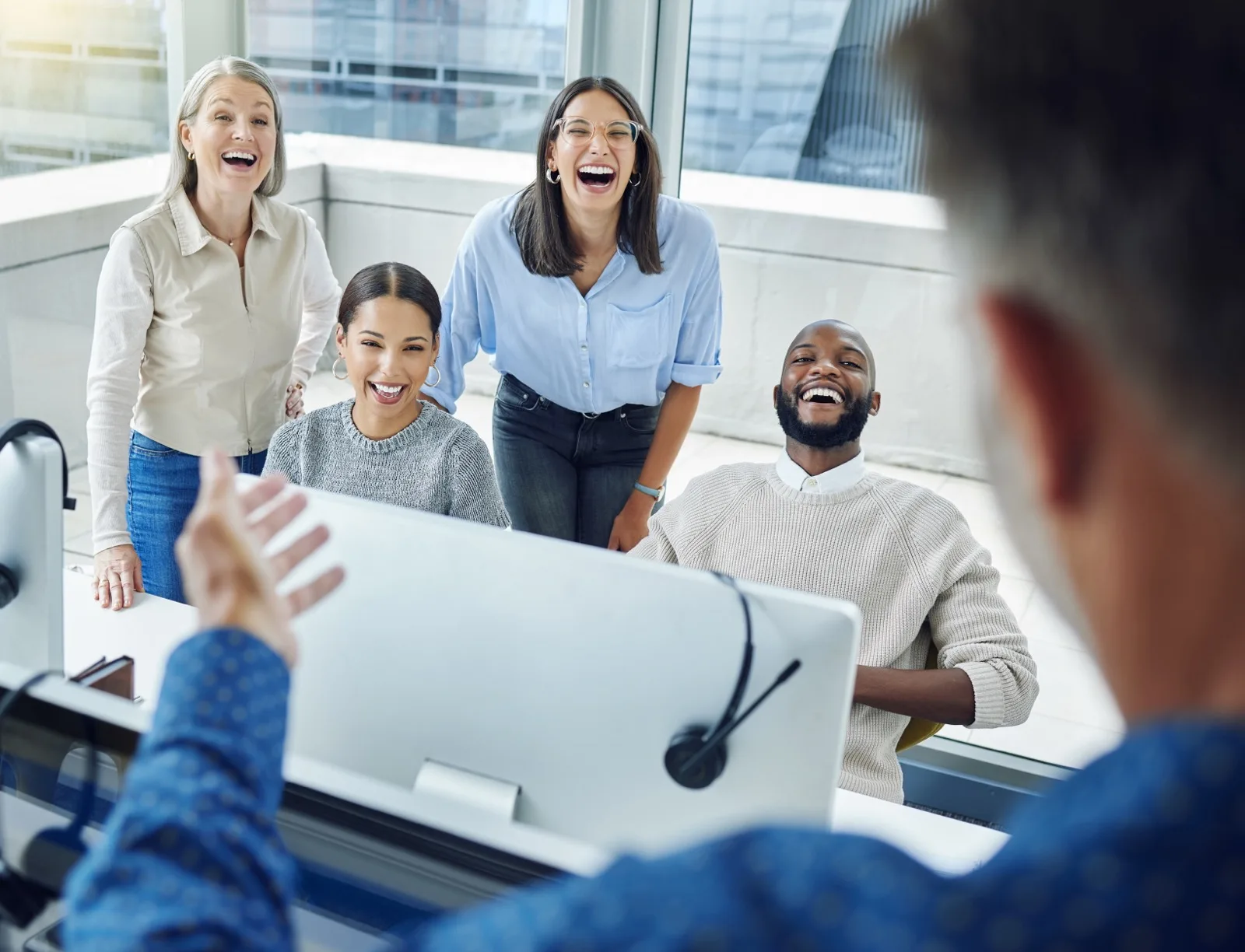 Team collaborating and laughing together in office